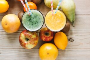 Close-up fruits around smoothie